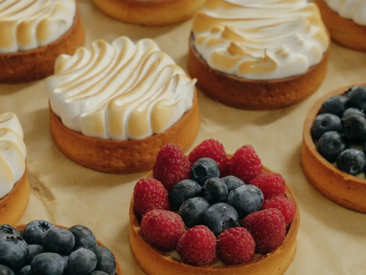 a bunch of desserts that are sitting on a table