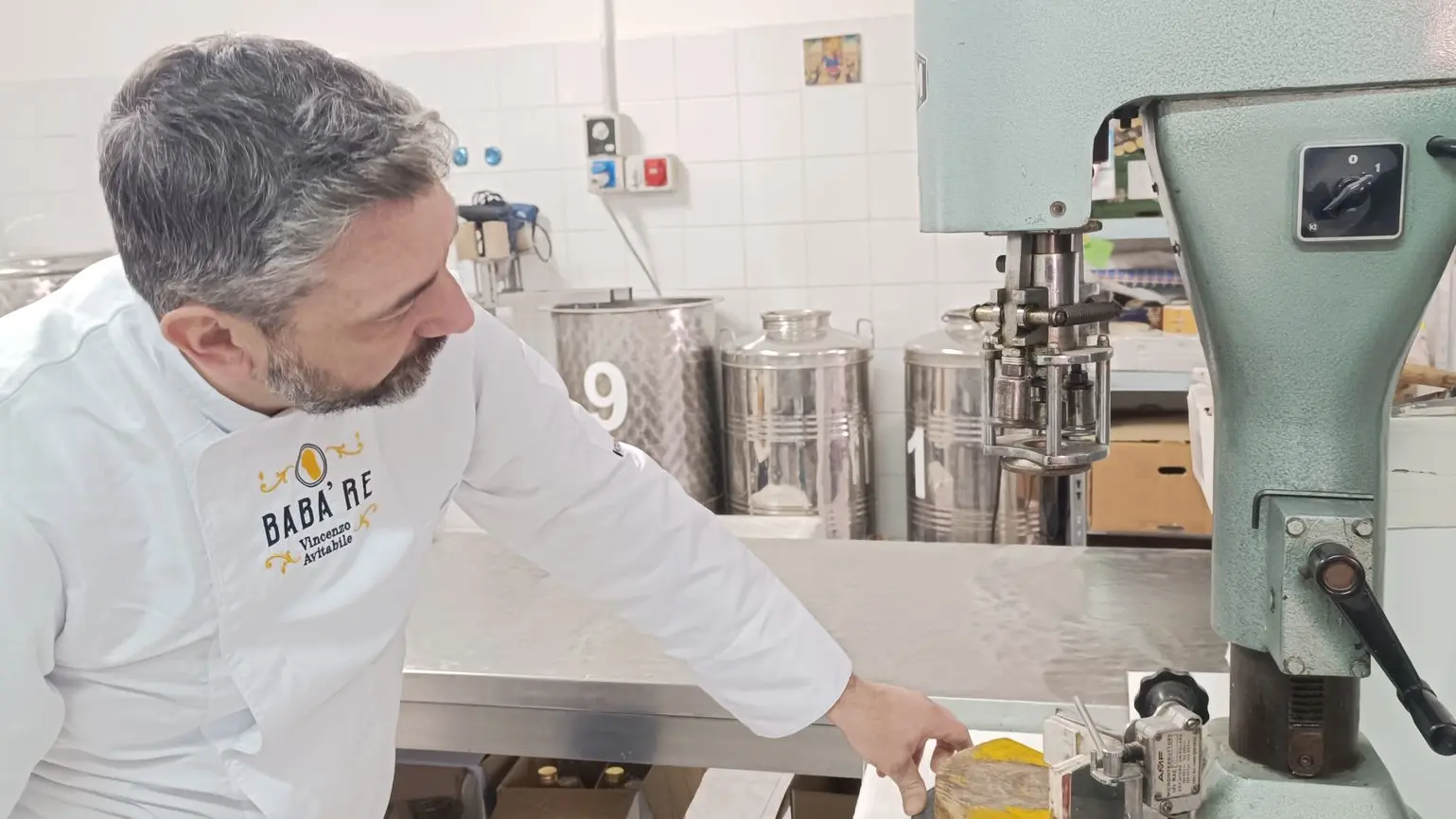 Uomo che guarda sotto macchinario per produzione liquori